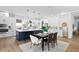 Modern kitchen with a blue island, white cabinetry, and stylish pendant lighting at 3317 W Napoleon Ave, Tampa, FL 33611