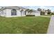 Front view of house with two-car garage and lush green lawn at 3623 Gaviota Dr, Sun City Center, FL 33573