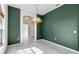 Dining room with decorative light fixture, dark green accent wall and tile flooring at 3623 Gaviota Dr, Sun City Center, FL 33573