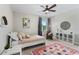 Cozy bedroom with full-size bed and ceiling fan at 4615 W El Prado Blvd, Tampa, FL 33629