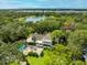 Luxury home with pool and lake views, surrounded by lush landscaping at 7877 98Th St, Seminole, FL 33777