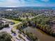 An aerial view showcasing a tranquil waterfront community and nearby roadways at 1028 Orca Ct, Holiday, FL 34691