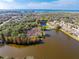 Aerial view of waterfront community with lush trees and calm waters at 1028 Orca Ct, Holiday, FL 34691