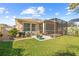Spacious backyard with screened patio, landscaping and lawn at 1028 Orca Ct, Holiday, FL 34691