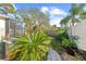 Landscaped backyard with a screened patio and brick pavers at 1028 Orca Ct, Holiday, FL 34691