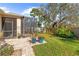 Private backyard oasis with screened patio and lush landscaping at 1028 Orca Ct, Holiday, FL 34691