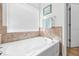 Relaxing bathroom with a large garden tub and tile surround at 1028 Orca Ct, Holiday, FL 34691