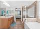 Elegant bathroom with double vanity, a soaking tub and walk-in shower at 1028 Orca Ct, Holiday, FL 34691