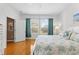 Main bedroom with a king-size bed and wood floors at 1028 Orca Ct, Holiday, FL 34691