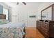 Spacious bedroom with a dresser, large bed, and double doors at 1028 Orca Ct, Holiday, FL 34691