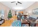 Open and bright living room showcasing hardwood floors and a view into the kitchen area at 1028 Orca Ct, Holiday, FL 34691