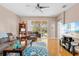 Bright living room with hardwood floors, comfy seating, and sliding glass doors leading to the patio at 1028 Orca Ct, Holiday, FL 34691