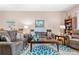 Comfortable living room with hardwood floors, neutral decor, and ample seating for guests at 1028 Orca Ct, Holiday, FL 34691