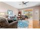 Living room with comfy seating, large windows, and wood floors at 1028 Orca Ct, Holiday, FL 34691