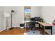 Home office with corner desk, chair and wood floors at 1028 Orca Ct, Holiday, FL 34691