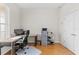Home office with corner desk, chair and wood floors at 1028 Orca Ct, Holiday, FL 34691