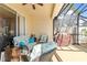 Relaxing screened porch with seating and grill at 1028 Orca Ct, Holiday, FL 34691