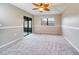 Bedroom with gray carpeting and sliding glass doors at 12900 Vonn Rd # A202, Largo, FL 33774