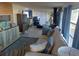 Bright living room with comfy sofa, large windows, and a tiled floor at 164 Colonial Ct # 19, Palm Harbor, FL 34684