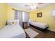 Guest bedroom with twin beds and cheerful yellow walls at 211 S Mcmullen Booth Rd # 189, Clearwater, FL 33759
