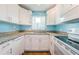 Bright kitchen with white cabinets and granite countertops at 211 S Mcmullen Booth Rd # 189, Clearwater, FL 33759