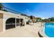Community pool area with pool house and lounge chairs at 211 S Mcmullen Booth Rd # 189, Clearwater, FL 33759