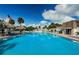 Inviting community pool with lounge chairs and palm trees at 211 S Mcmullen Booth Rd # 189, Clearwater, FL 33759