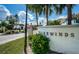 Tradewinds community entrance with signage and lush landscaping at 211 S Mcmullen Booth Rd # 189, Clearwater, FL 33759