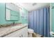 Bathroom with granite vanity and blue shower curtain at 211 S Mcmullen Booth Rd # 189, Clearwater, FL 33759