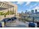 Balcony with city skyline views, modern outdoor furniture, glass railings, and pergola at 226 5Th N Ave # 706, St Petersburg, FL 33701