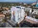 Aerial view of a modern white condominium building featuring a mural of a Personal on its facade at 226 5Th N Ave # 706, St Petersburg, FL 33701