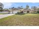 Two-story house with a three-car garage and manicured lawn at 33536 Westwood Dr, Dade City, FL 33523