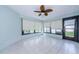 Relaxing sunroom, featuring tile floors and backyard access at 3647 Muirfield Ct, New Port Richey, FL 34655