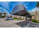 Inviting building entrance with covered awning, ample parking, and landscaping at 3647 Muirfield Ct, New Port Richey, FL 34655