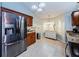 Spacious kitchen featuring stainless steel refrigerator and wood cabinets at 3647 Muirfield Ct, New Port Richey, FL 34655