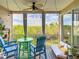 Relaxing screened balcony with outdoor furniture, string lights, and lush greenery views at 7287 Islamorada Cir, Seminole, FL 33777