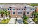 Tan three-story townhome with attached garage and balcony at 7287 Islamorada Cir, Seminole, FL 33777