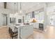 Modern kitchen with white cabinets, quartz countertops, and island seating at 149 Mossy River Ct, Brandon, FL 33511