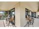 Covered balcony with two bistro tables and chairs at 1651 Sand Key Estates Ct # 52, Clearwater, FL 33767