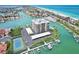 Aerial view of building, pool, tennis court, and marina at 1651 Sand Key Estates Ct # 52, Clearwater, FL 33767