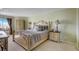 Elegant bedroom with a large bed, nightstands, and a wardrobe at 1651 Sand Key Estates Ct # 52, Clearwater, FL 33767