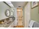 Main bathroom with a bathtub, granite vanity, and double sinks at 1651 Sand Key Estates Ct # 52, Clearwater, FL 33767