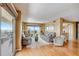 Living room with hardwood floors and access to a balcony with water views at 1651 Sand Key Estates Ct # 52, Clearwater, FL 33767