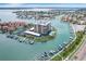 Aerial view of building, pool, tennis court, and marina at 1651 Sand Key Estates Ct # 52, Clearwater, FL 33767