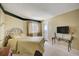 Comfortable bedroom with a queen-size bed, TV, and access to a balcony at 1651 Sand Key Estates Ct # 52, Clearwater, FL 33767