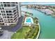 Aerial view of a condo building with pool and waterway access at 1651 Sand Key Estates Ct # 52, Clearwater, FL 33767
