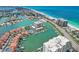 Aerial view of building, pool, tennis court, and marina at 1651 Sand Key Estates Ct # 52, Clearwater, FL 33767