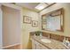 Bathroom with granite countertop, single sink vanity, and large mirror at 1651 Sand Key Estates Ct # 52, Clearwater, FL 33767