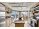 Modern kitchen with granite island and water views at 1651 Sand Key Estates Ct # 52, Clearwater, FL 33767