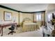 Bright bedroom with a queen-size bed, a desk, and large windows at 1651 Sand Key Estates Ct # 52, Clearwater, FL 33767